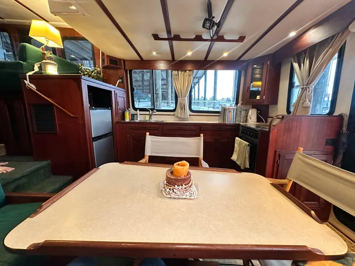 Ms. Moneypenny Yacht Photos Pics Interior of a 2001 Nordic Tug 37, featuring a cozy dining area and kitchen.