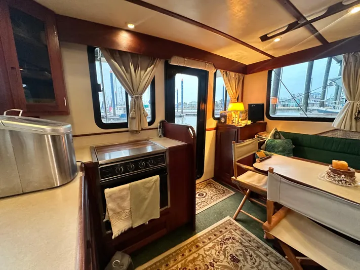 Ms. Moneypenny Yacht Photos Pics Interior of a 2001 Nordic Tug 37, featuring a cozy dining area and kitchen.