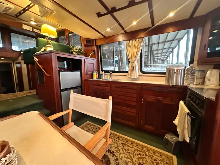 Ms. Moneypenny Yacht Photos Pics Interior of 2001 Nordic Tug 37, featuring a cozy kitchen and dining area.