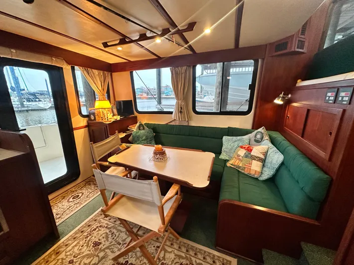 Ms. Moneypenny Yacht Photos Pics Interior of 2001 Nordic Tug 37, featuring cozy seating and nautical decor.