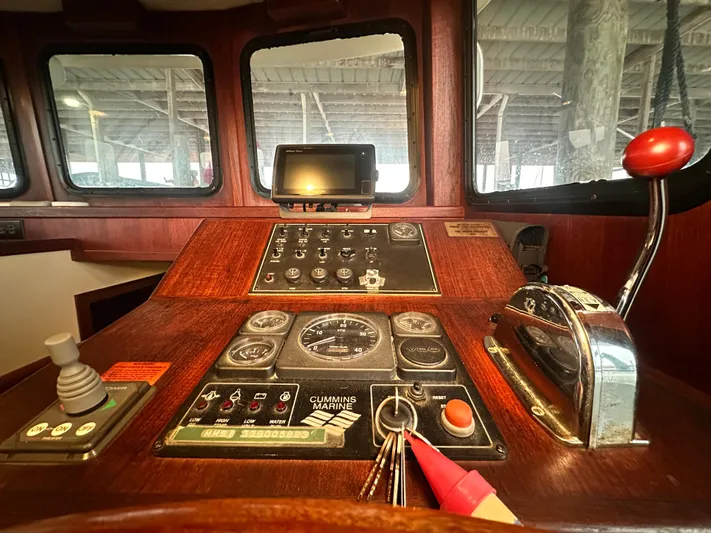 Ms. Moneypenny Yacht Photos Pics Control panel of a 2001 Nordic Tug 37 boat, featuring navigation and engine controls.