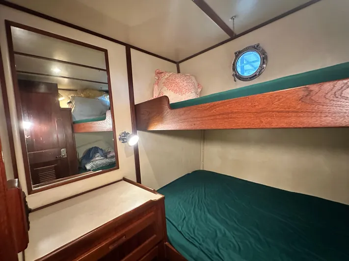 Ms. Moneypenny Yacht Photos Pics Cozy cabin with bunk beds in 2001 Nordic Tug 37 boat interior.