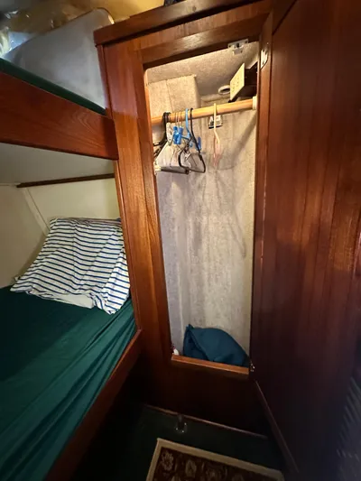 Ms. Moneypenny Yacht Photos Pics Wooden closet and bunk bed in 2001 Nordic Tug 37 boat interior.