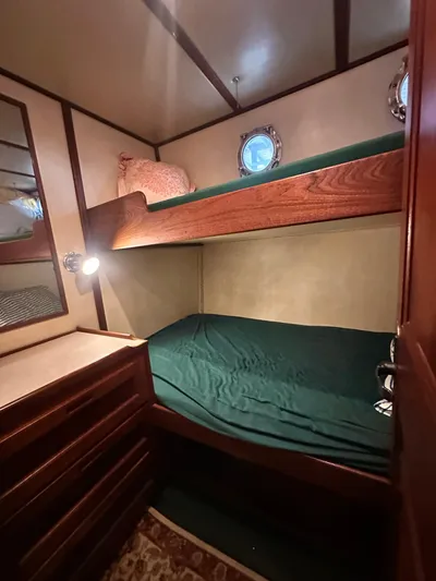 Ms. Moneypenny Yacht Photos Pics 2001 Nordic Tug 37 cabin with bunk beds and wooden interior.