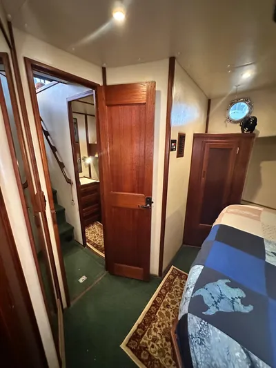 Ms. Moneypenny Yacht Photos Pics Interior of a 2001 Nordic Tug 37, featuring wooden doors and cozy cabin decor.