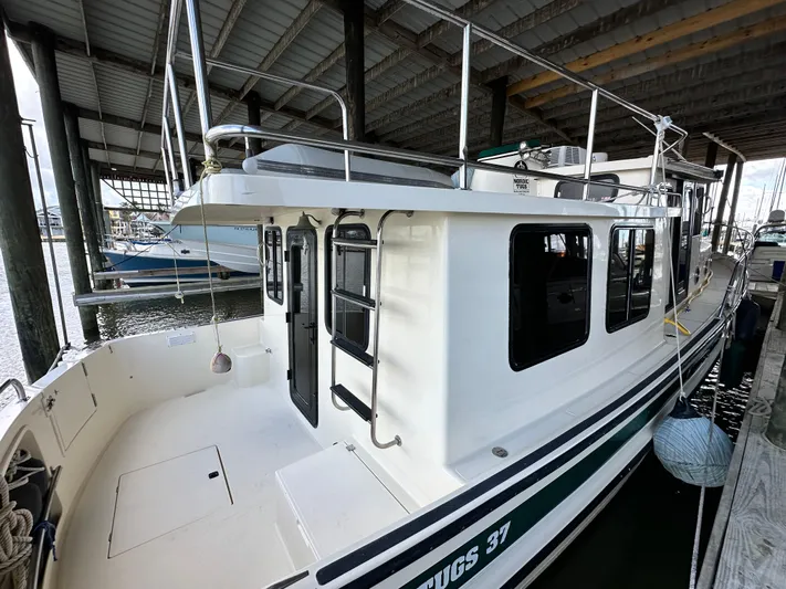 Ms. Moneypenny Yacht Photos Pics 2001 Nordic Tug 37 docked under a covered marina.