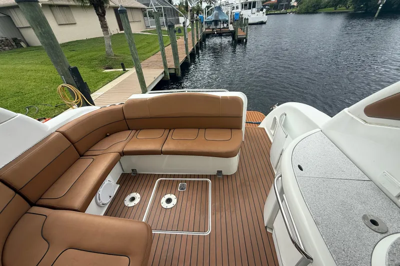  Yacht Photos Pics 2009 Formula 40 Performance Cruiser with brown leather seating and teak deck by a dock.
