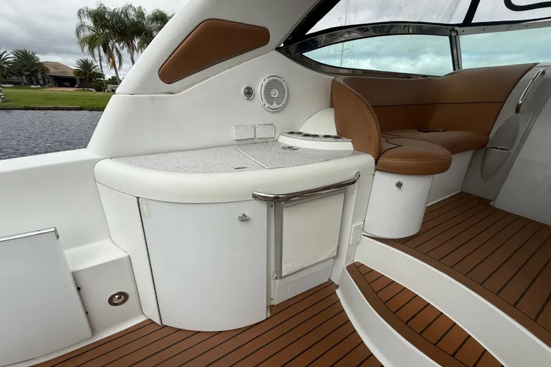  Yacht Photos Pics 2009 Formula 40 Performance Cruiser interior with seating and kitchenette, featuring wood-style flooring.