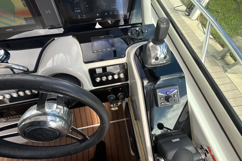  Yacht Photos Pics Control panel of a 2009 Formula 40 Performance Cruiser with steering wheel and navigation instruments.