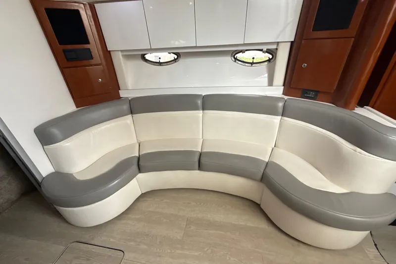  Yacht Photos Pics Luxurious interior of 2009 Formula 40 Performance Cruiser with curved seating and modern cabinetry.