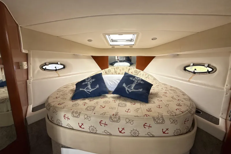  Yacht Photos Pics 2009 Formula 40 Performance Cruiser cabin with nautical-themed bedding and porthole windows.