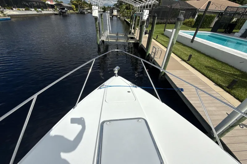  Yacht Photos Pics 2009 Formula 40 Performance Cruiser docked by a canal with poolside view.