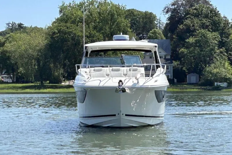  Yacht Photos Pics 2020 Sea Ray Sundancer 320 Outboard cruising on a serene lake with lush greenery.
