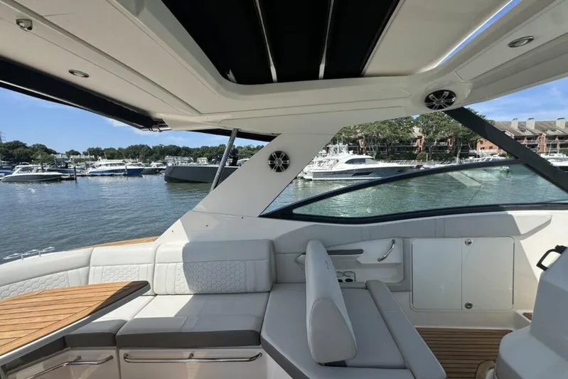  Yacht Photos Pics 2020 Sea Ray Sundancer 320 Outboard interior with luxurious seating, overlooking marina.