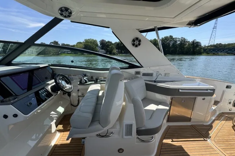  Yacht Photos Pics 2020 Sea Ray Sundancer 320 Outboard interior with helm, seating, and water view.
