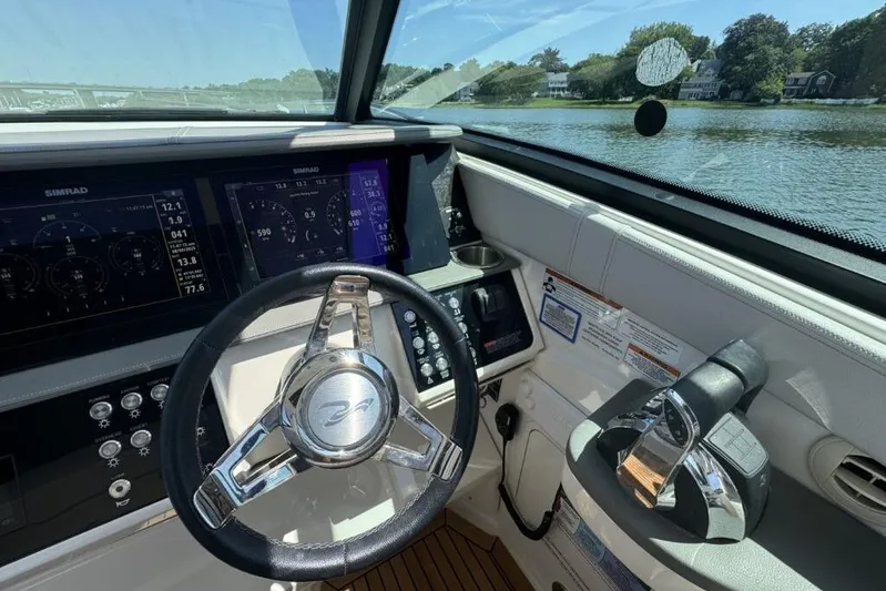  Yacht Photos Pics Cockpit of 2020 Sea Ray Sundancer 320 Outboard with modern controls and scenic water view.