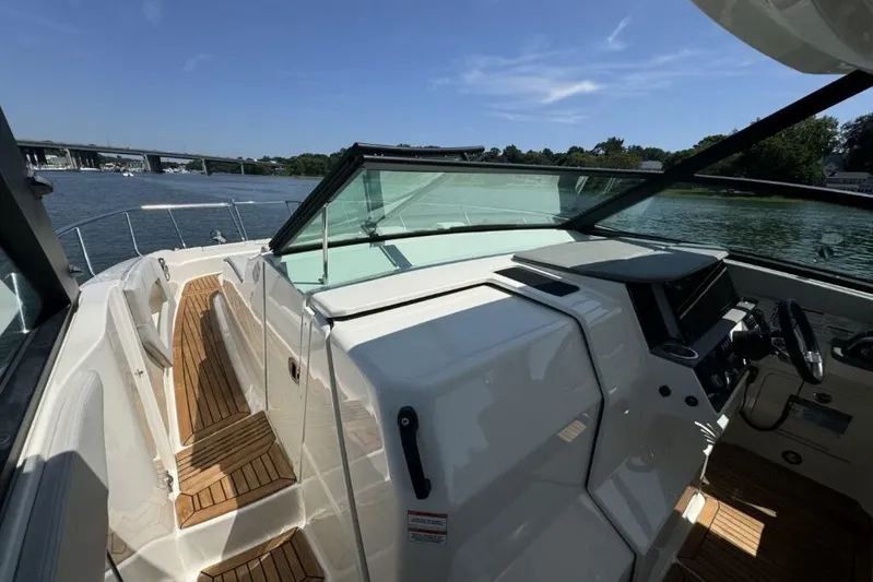  Yacht Photos Pics 2020 Sea Ray Sundancer 320 Outboard boat interior with wooden deck and steering console.