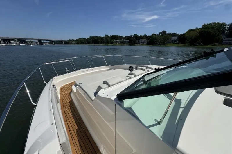  Yacht Photos Pics 2020 Sea Ray Sundancer 320 Outboard cruising on a serene river under a clear blue sky.