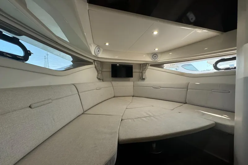  Yacht Photos Pics 2020 Sea Ray Sundancer 320 Outboard cabin interior with beige seating and windows.