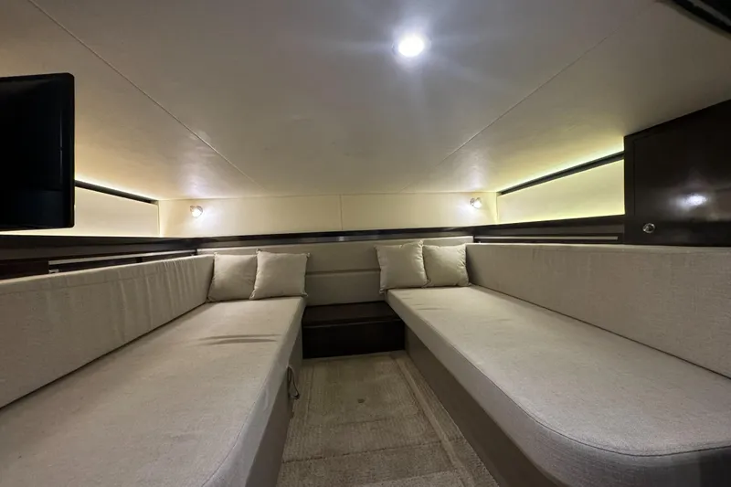  Yacht Photos Pics Interior cabin of 2020 Sea Ray Sundancer 320 Outboard, featuring cozy seating and ambient lighting.