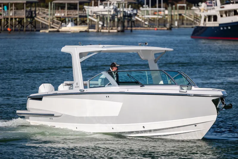  Yacht Photos Pics 2023 Aviara AV32 OB boat cruising on a calm waterway.