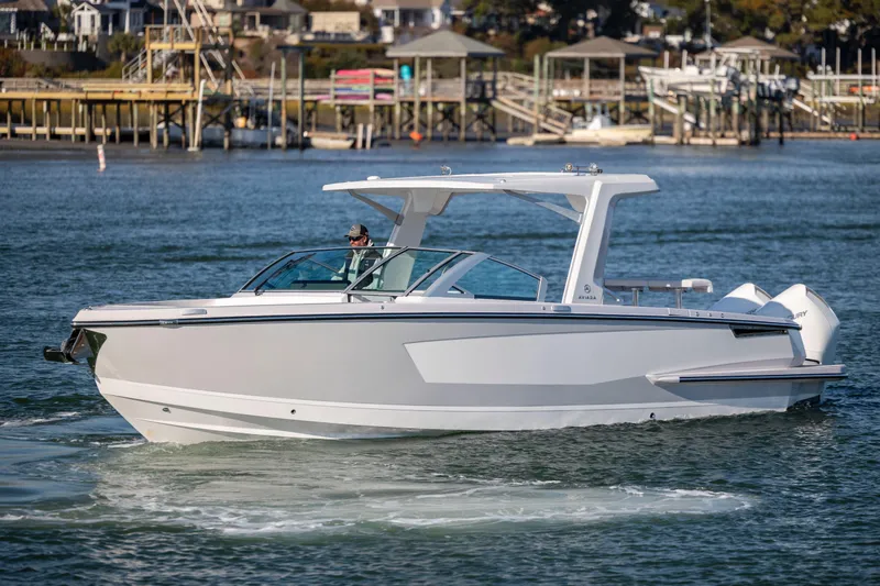 Yacht Photos Pics 2023 Aviara AV32 OB boat cruising on a calm waterfront.