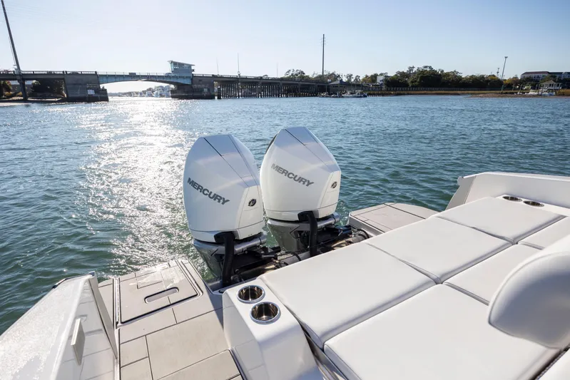  Yacht Photos Pics 2023 Aviara AV32 OB boat with dual Mercury outboard engines on a sunny waterway.