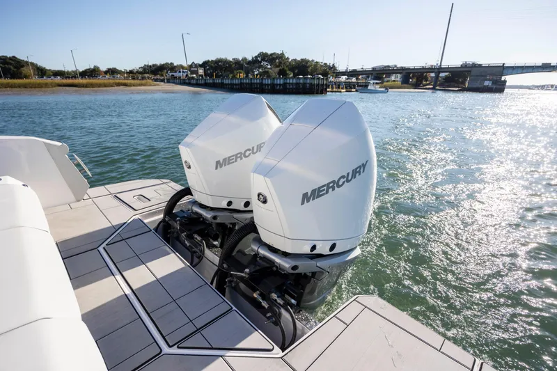  Yacht Photos Pics 2023 Aviara AV32 OB with dual Mercury outboard engines on a sunny waterway.