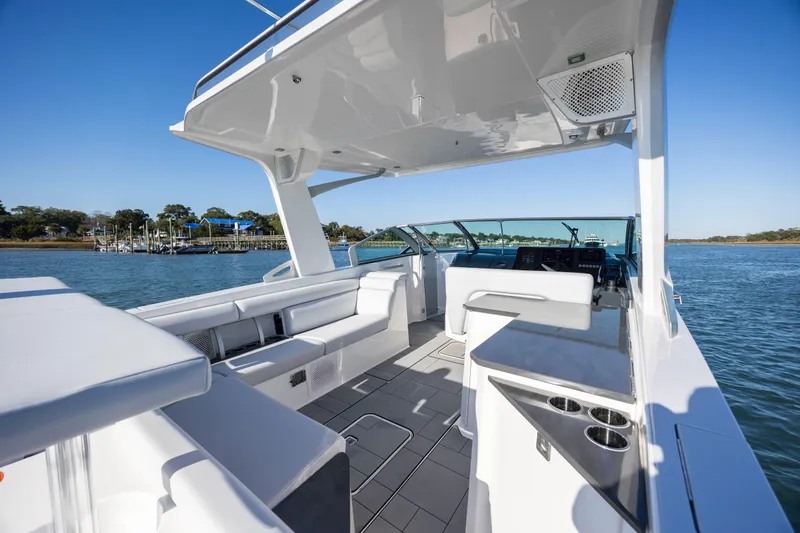  Yacht Photos Pics 2023 Aviara AV32 OB luxury boat interior with sleek seating and modern design on a sunny day.