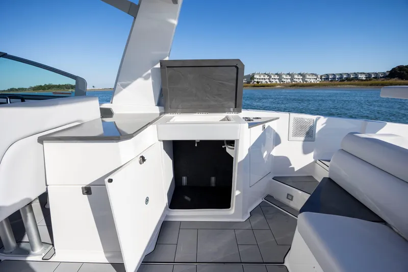  Yacht Photos Pics 2023 Aviara AV32 OB boat interior with open storage, sleek design, and waterfront view.