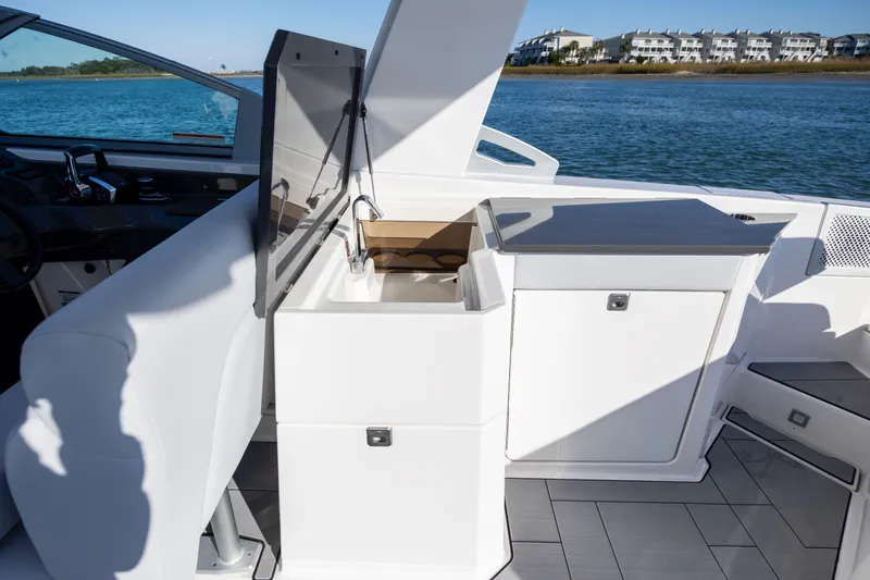  Yacht Photos Pics 2023 Aviara AV32 OB boat interior with sleek kitchenette and water view.