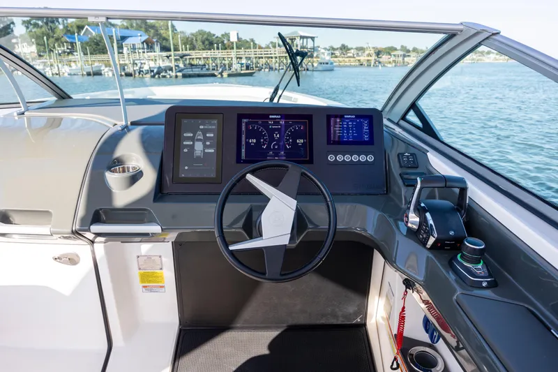  Yacht Photos Pics Helm of 2023 Aviara AV32 OB boat with modern controls and digital displays.