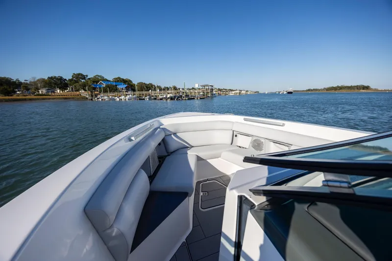  Yacht Photos Pics 2023 Aviara AV32 OB boat on calm water, featuring spacious seating and sleek design.