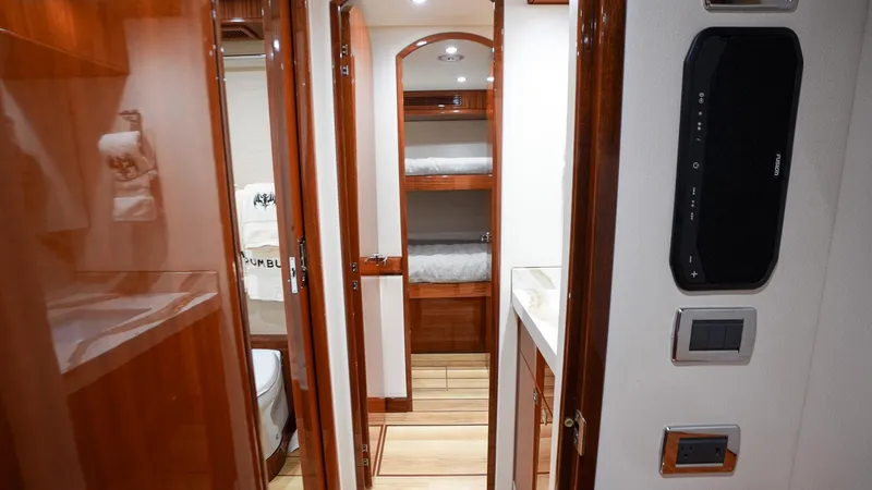  Yacht Photos Pics Luxurious interior of 2024 Hatteras GT70 yacht with wood finishes and modern amenities.
