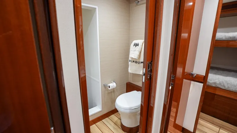  Yacht Photos Pics Luxurious bathroom in 2024 Hatteras GT70 yacht with wooden accents.