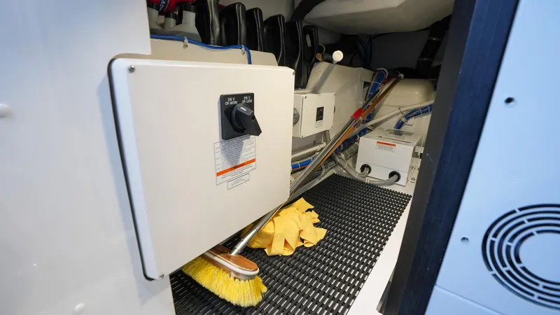  Yacht Photos Pics 2024 Hatteras GT70 engine room with cleaning supplies and equipment.