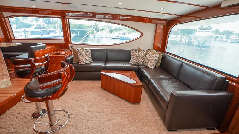  Yacht Photos Pics Luxurious interior of 2024 Hatteras GT70 yacht with leather seating and elegant wood finishes.