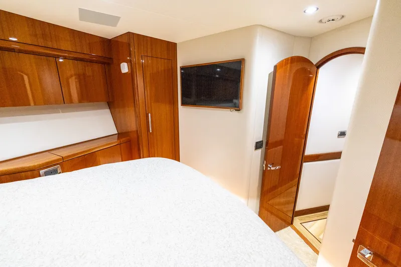  Yacht Photos Pics Luxurious cabin interior of 2024 Hatteras GT70 yacht with wood finishes and modern amenities.