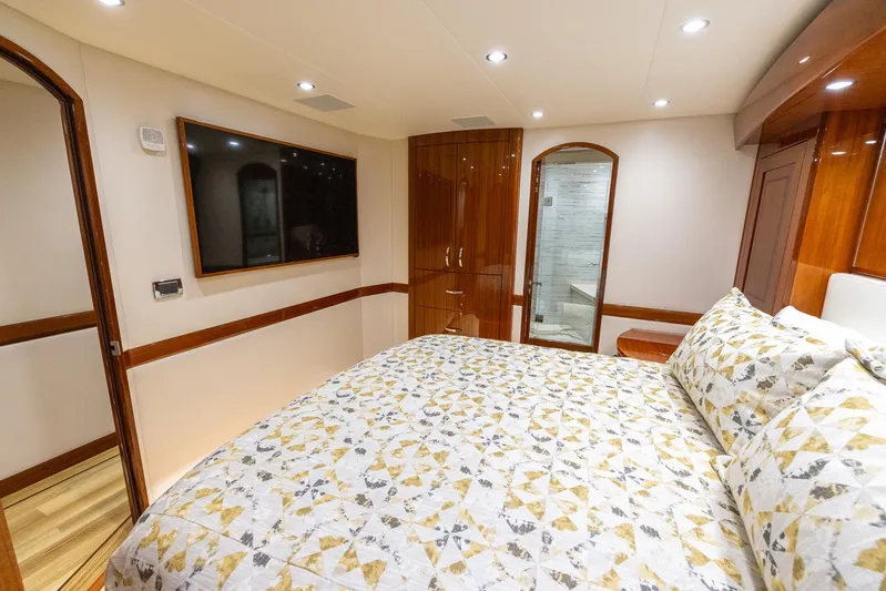  Yacht Photos Pics Luxurious bedroom interior of 2024 Hatteras GT70 yacht with modern amenities.