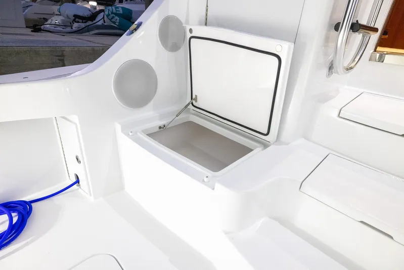  Yacht Photos Pics 2024 Hatteras GT70 yacht deck with open storage compartment and blue cable.