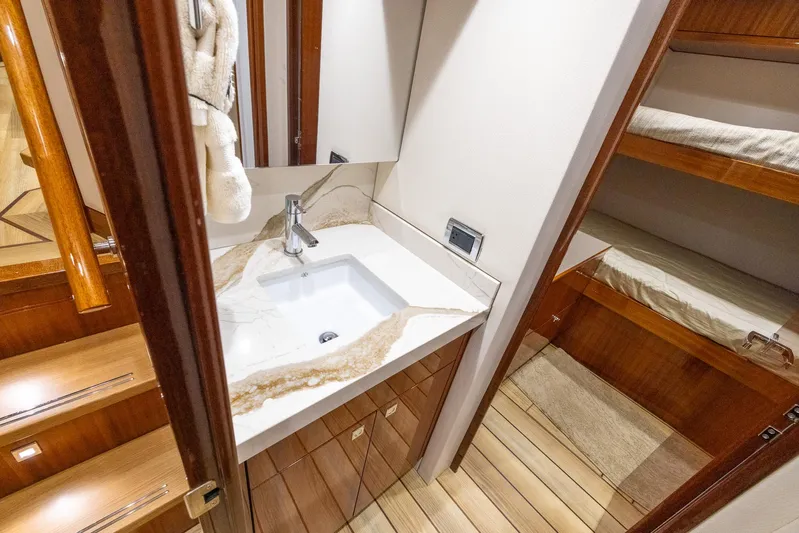  Yacht Photos Pics 2024 Hatteras GT70 yacht interior with modern bathroom and wooden accents.