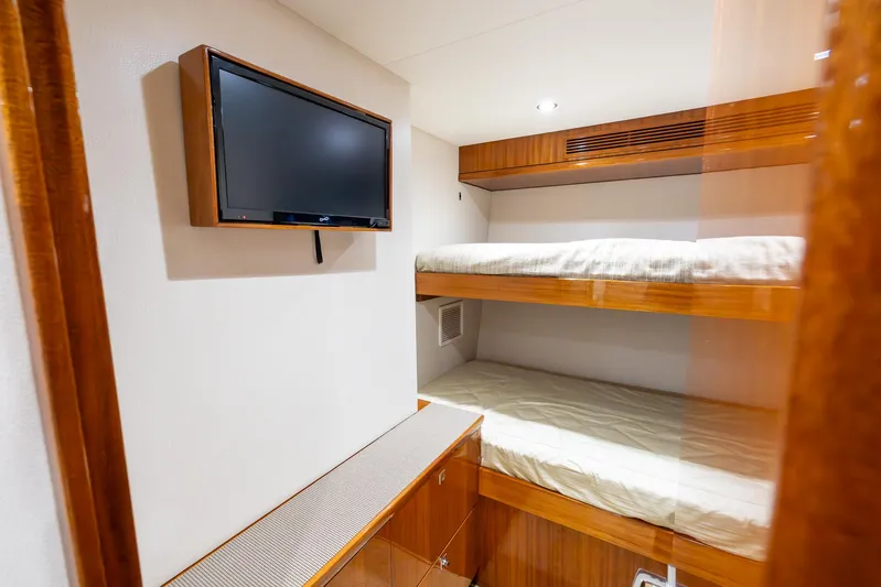  Yacht Photos Pics 2024 Hatteras GT70 cabin with bunk beds and wall-mounted TV.
