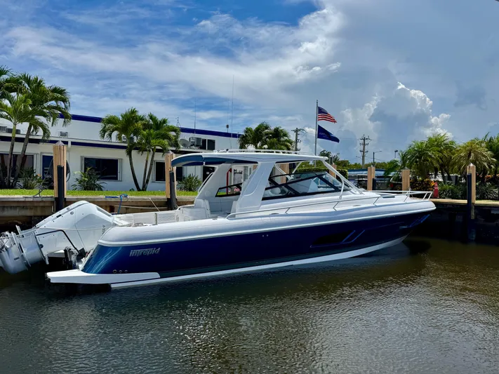  Yacht Photos Pics 2026 Intrepid 438 Evolution boat docked, featuring sleek design and modern outboard engines.