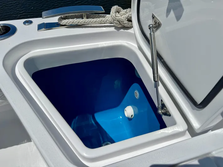  Yacht Photos Pics Open storage compartment on 2026 Intrepid 438 Evolution boat, featuring a blue interior.
