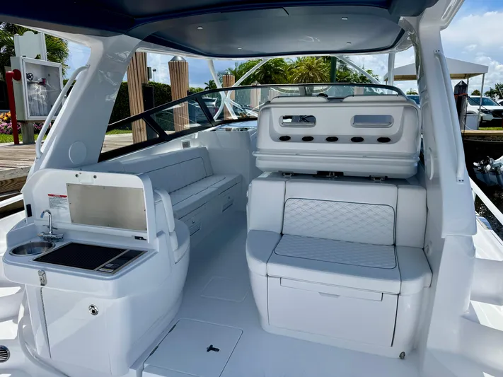  Yacht Photos Pics Luxurious interior of 2026 Intrepid 438 Evolution yacht with seating and kitchenette.