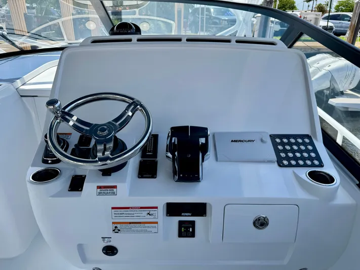  Yacht Photos Pics Helm of 2026 Intrepid 438 Evolution boat with steering wheel and controls.
