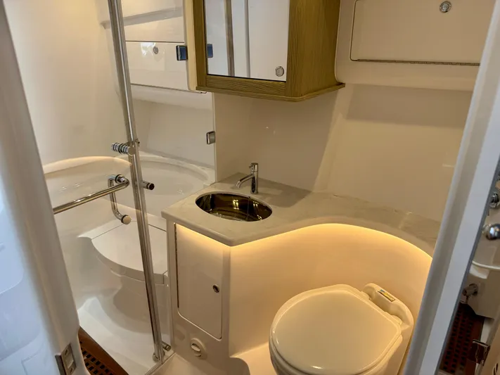  Yacht Photos Pics Luxurious bathroom in 2026 Intrepid 438 Evolution yacht, featuring modern fixtures and ambient lighting.