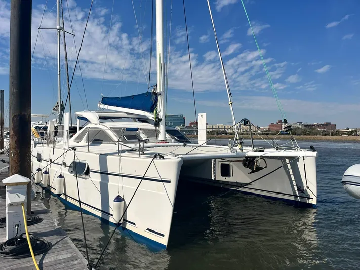 Tao Yacht Photos Pics 2005 Catana 43 Ocean Class catamaran docked at marina under blue sky.