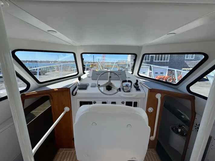 Resolute Yacht Photos Pics Interior helm of 2020 Cape Powercat 3500 PH with panoramic windows and modern controls.