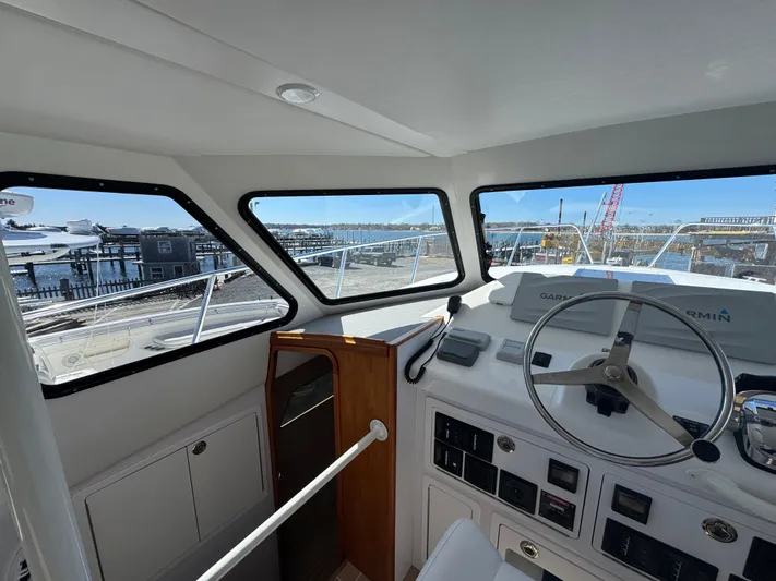 Resolute Yacht Photos Pics Interior view of 2020 Cape Powercat 3500 PH boat helm with marina background.